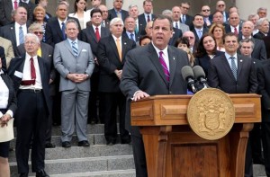 Gov. Christie rallies bi-partisan gaggle in support of arb cap renewal.
