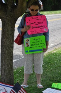A woman protests Governor Christie's pension payment walk-back at his 6/25/14 Haddon Heights Town Hall (photo credit: Alyssa LaFage)