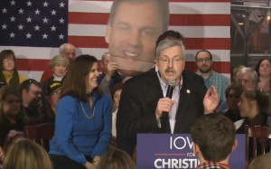 The Christie couple rallies with Governor Branstad (center) in West Des Moines on Iowa Caucus Eve.